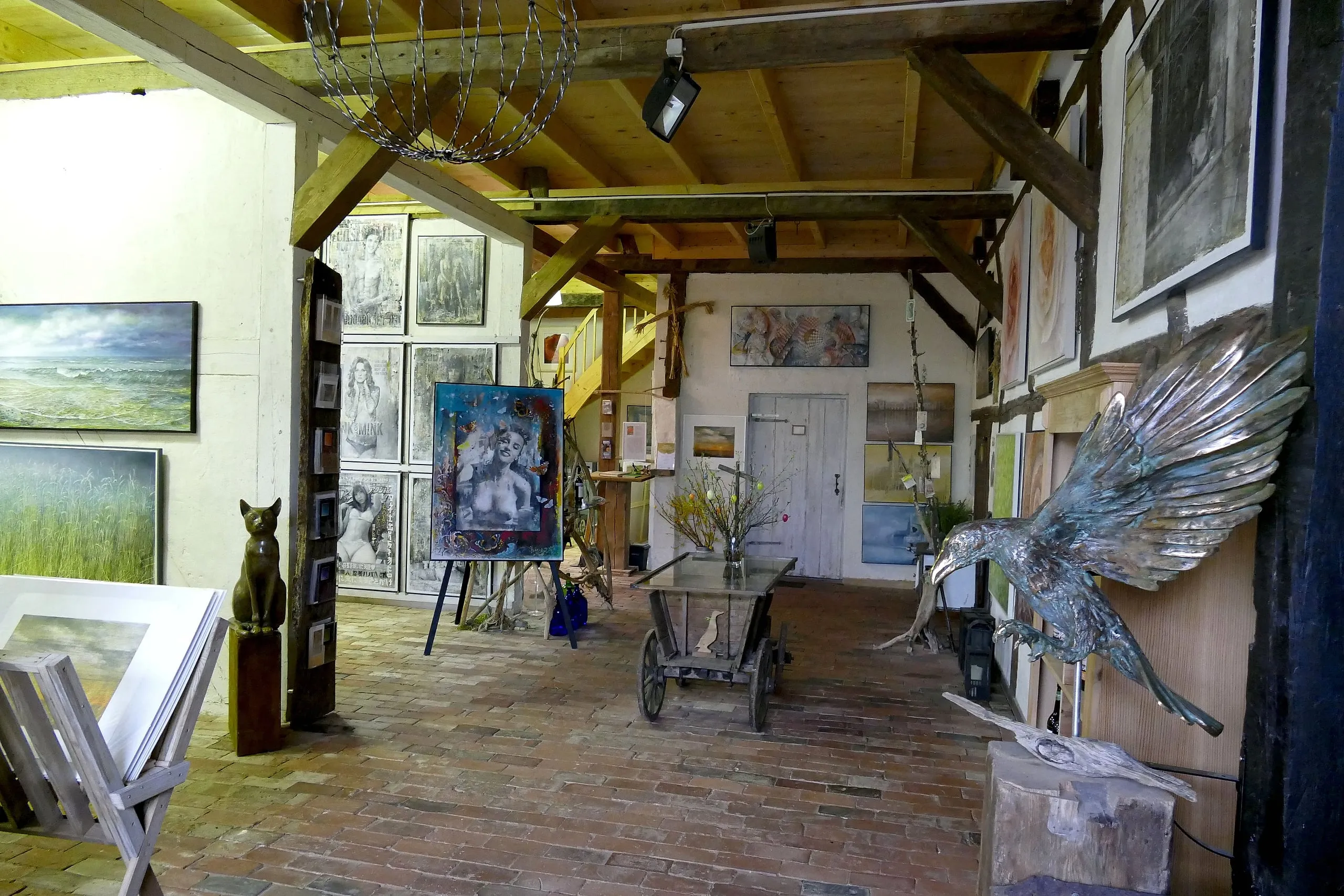 Ground-floor exhibition room with paintings and a bronze sculpture
