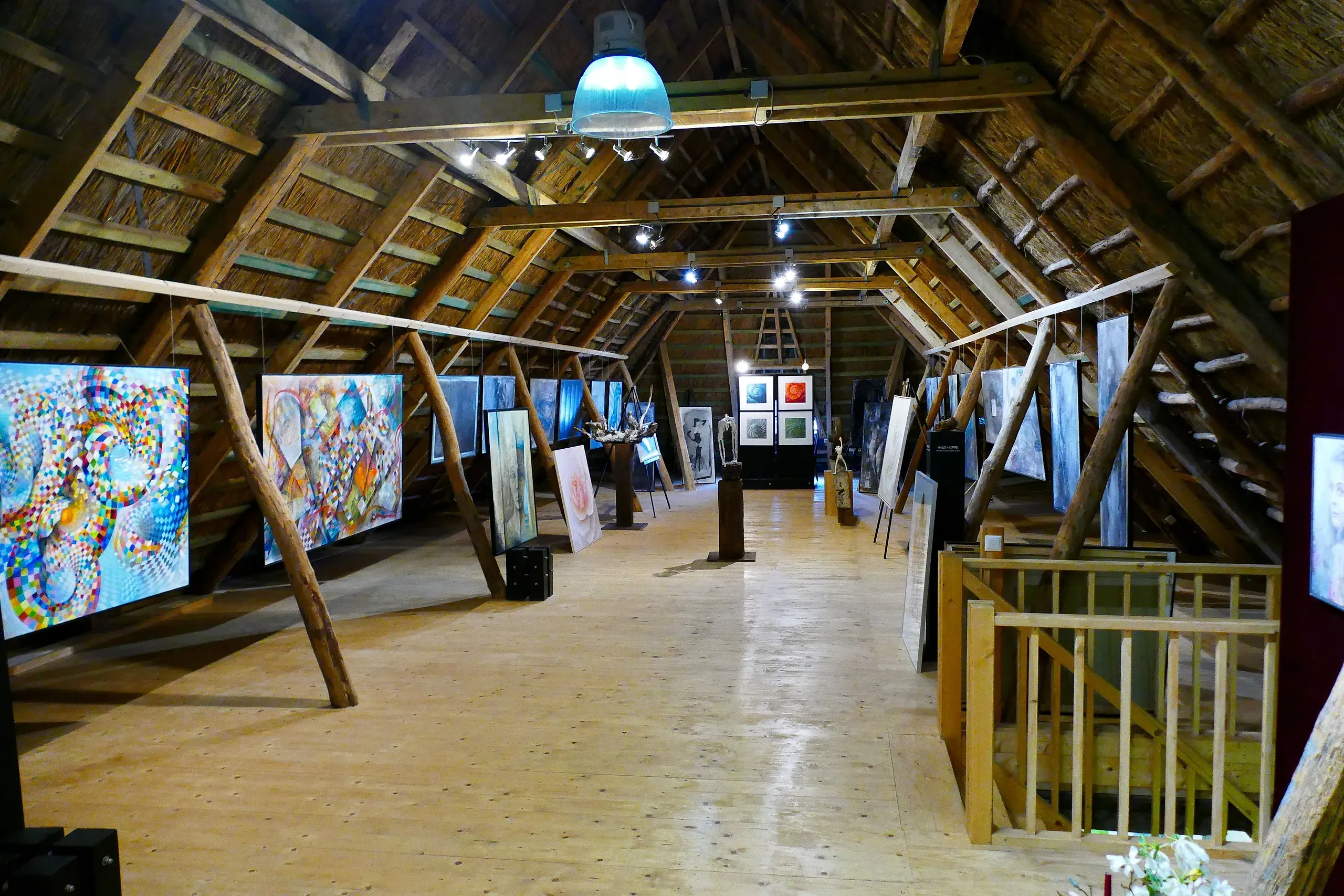 Paintings beneath the historic timber roof in the loft of the barn