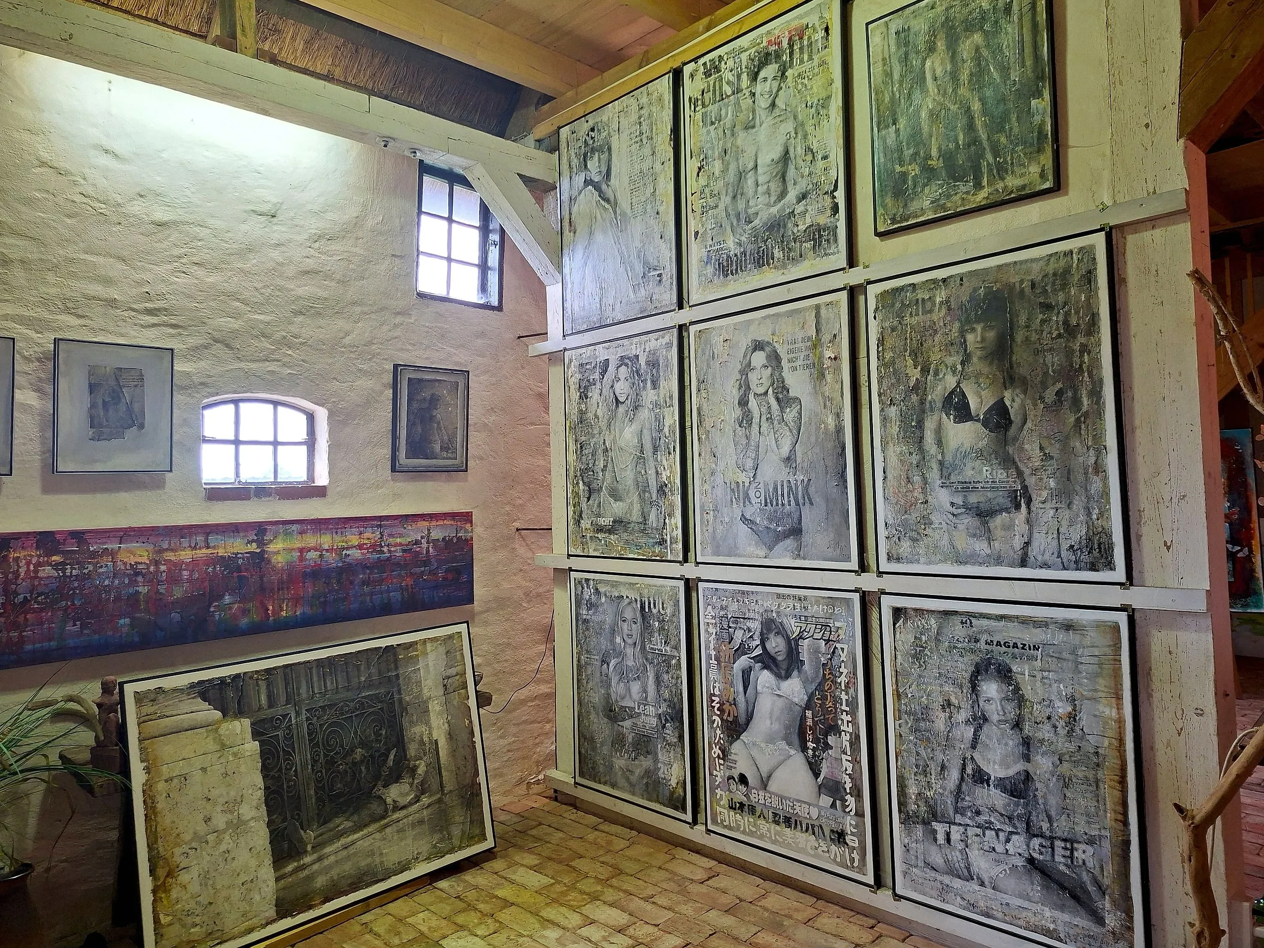 Wall of large framed works by Olaf Hoppe in the exhibition room
